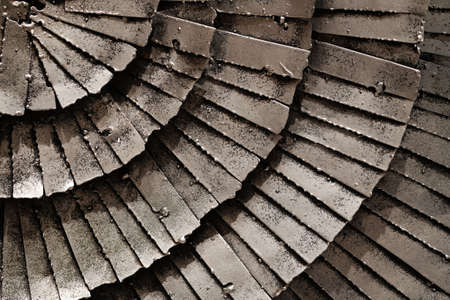 Stacking silver iron plates in curving patternの写真素材