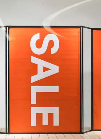 Big sale sign on red background poster in front of storeの写真素材