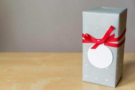 Gift box on wooden table with copy space on greeting card, clipping path included