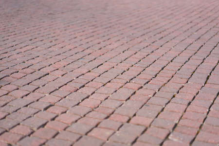 Red brick tile pavement, floor background, with depth of field effectの写真素材