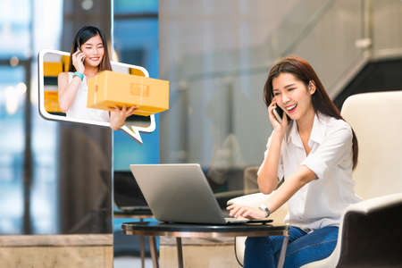 Beautiful Asian girl shop online using phone call with female small business owner delivering parcel box. Internet shopping lifestyle, Ecommerce, shipment service, SME sale promotion advertise concept