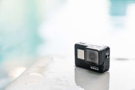 Bangkok, Thailand - Sep 28, 2018: New GoPro Hero 7 Black action camera on wet surface at swimming pool with copy space. Illustrative editorial contentのeditorial素材
