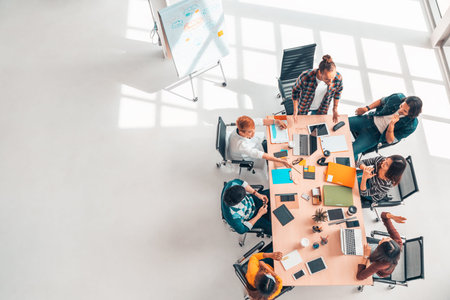 Multiethnic diverse group of business coworkers in team meeting discussion, top view modern office...