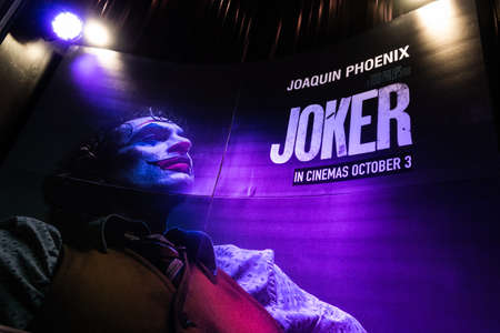 Bangkok, Thailand - Oct 1, 2019: Joker movie backdrop poster with spotlights showing in movie theatre. Cinema promotional advertisement, or film industry marketing conceptのeditorial素材