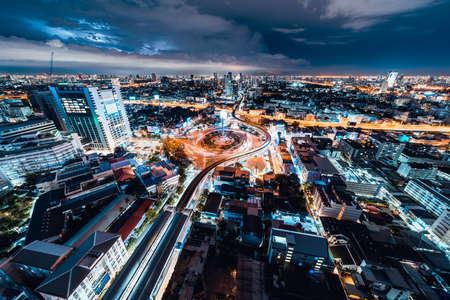 Bangkok, Thailand - Sep 7, 2020: Cityscape view of car traffic transportation at the Victory Monument roundabout at night. Asian city life, Asia travel landmark, public transport conceptのeditorial素材