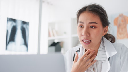 Asian female doctor using laptop computer online video call remote talking to patient, prescribe medicine. Tele medical, telehealth, hospital clinic health care service, or internet technology conceptの写真素材