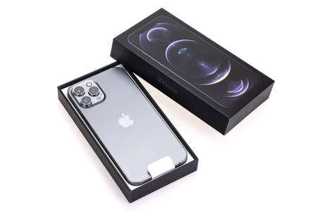 Bangkok, Thailand - Apr 27, 2021: Studio shot of new Apple iPhone 12 Pro Max graphite color, unbox showing phone lens and Apple logo. Isolate on white background. Illustrative editorial contentのeditorial素材