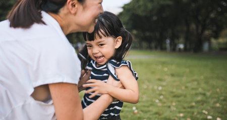 Young Asian mother hold cute daughter with smile. Mom kid love relationship or happy child girl...