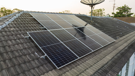 Solar grid panels on domestic house rooftop in Asia evening. Drone aerial view. Natural perpetual power technology, clean sustainable energy, zero waste lifestyle concept.の写真素材