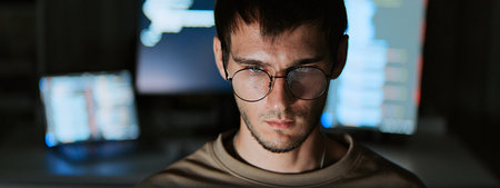 Software developer work late night, program coding in home office. Computer engineering job, data scientist, cybersecurity, information technology. Close-up eyeglasses, copy spaceの写真素材