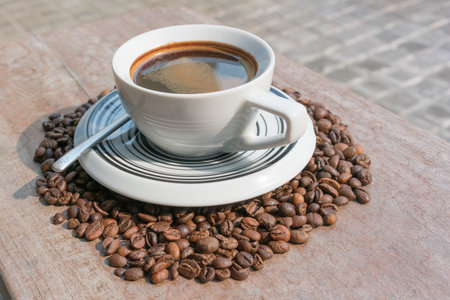 Dark Coffee in the middle of coffee beans