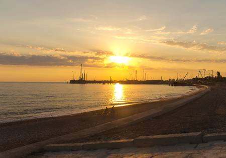 sunset sunlight beach town fishermen fishing in the shore is beautifulの写真素材
