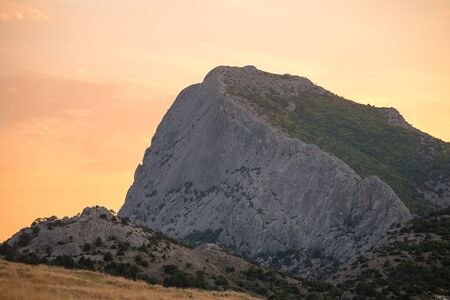 highest mountain with steep slope at dawn or sunset light pale pink skyの写真素材