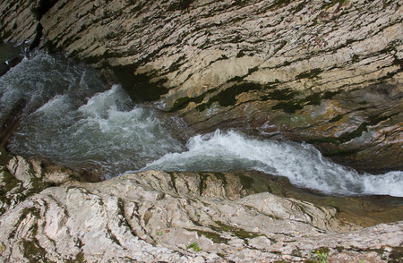 mountain river turns into a small beautiful waterfallの写真素材