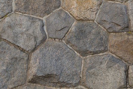 background base wall composed of hexagonal octagonal stones strong reliable light grayの写真素材
