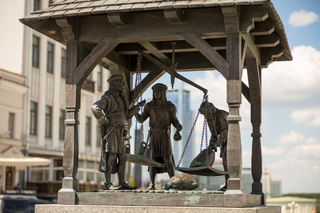 Minsk republic of Belarus-bronze statue medieval merchants weigh goods on the central square of the old city May 2016のeditorial素材