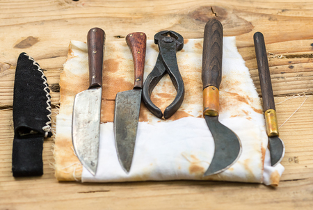 Ancient medical instruments dentistry surgery help on a wooden table backgroundの写真素材