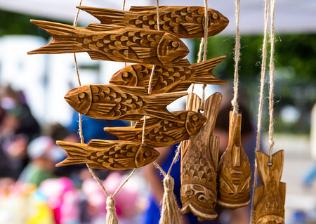 Garland handmade wooden carved fish figure weathered natural textureの写真素材