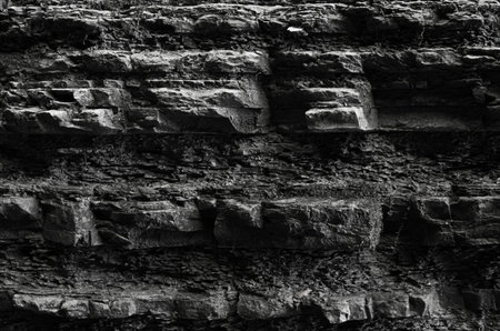 wall stone texture natural. uneven canyon gorge with protrusions pattern geology dark