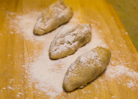 formation of cakes with fillings. raw before staging in the oven on a wooden backgroundの写真素材