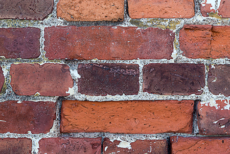 part of an old weathered brick wall with cement lines seams rectangular blocksの写真素材