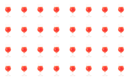 glass of cocktail sunrise blend of bright orange juice syrups cranberry and alcohol gin sambuca tequila red bright drinkの写真素材