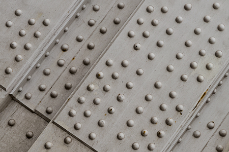 metal base rivets part engineering technology grunge silver overprint surface industrial backgroundの写真素材