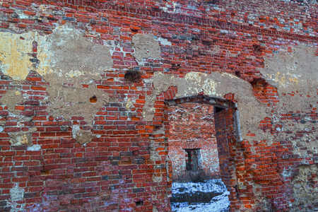 ruins old weather-beaten building view of the center of the house failure wasteland covered with snow scenery destruction accident walls brick weathered splinters of plasterの写真素材