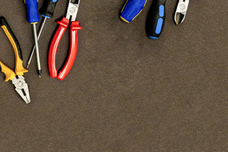 construction background set of tools blue screwdriver cutting pliers on a dark background design...