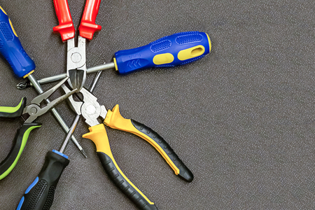 gray metal tool repair set of screwdrivers pliers crossed background design industrial base webの写真素材
