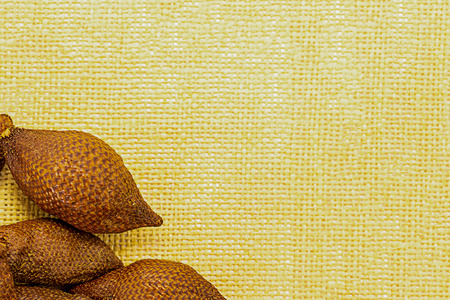 fruit set frame on a background of yellow canvas decoration decor basis copy space snake fruit asia malaysia thailand Salak mockupの写真素材