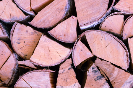 wooden logs chopped with bark birch background brown end cracked stack background rustic fuel