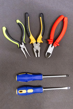 pair of screwdrivers rubber handles parallel hand tools three pliers pliers set constructionの写真素材