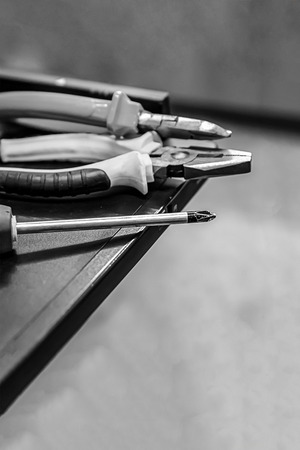 set of hand tools repair fasteners screwdriver pliers repair computer server monochrome. Gray monochrome grunge backgroundの写真素材