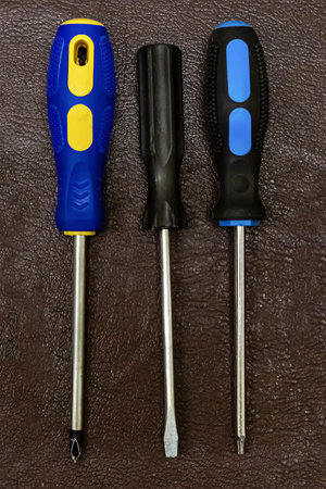 set of screwdrivers three hand-held fixing tools home repairman on dark background design baseの写真素材