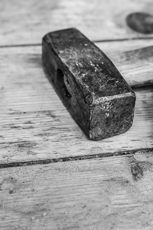 big hammer sledgehammer head tool on background blackboard close-up toned designの写真素材