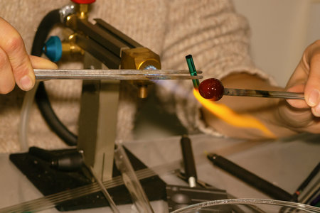 glassblower manufacture of products glass heating over high heat of a gas burner close-up