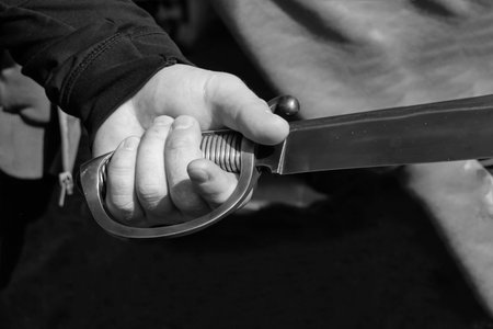 hand man ribbed handle wide knife hilt sword part of arms close-up toned design base web site