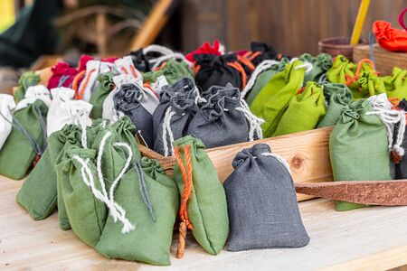 set green olive gray bag mini burlap white braid on a wooden table counter background rustic traditional packingの写真素材