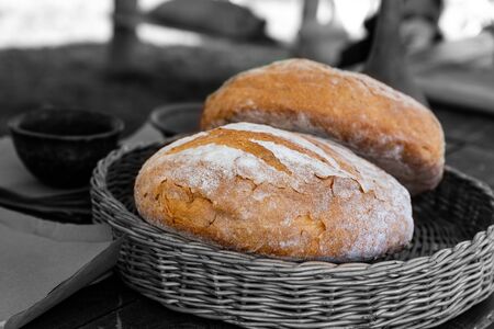 bright brown fresh baking bread tinted basket background contrasted base highlightedの写真素材