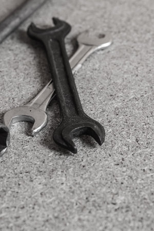 crossed metal wrenches, auto mechanic tool in gray colors