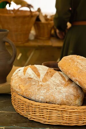 rustic and traditional warm soft bread folded in a basket vertical photoの写真素材