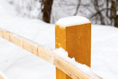 wooden fence limited snow-covered railing of the bridge, a walk on a winter dayの写真素材