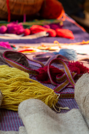 yarn lies on a canvas next to colorful ribbons, tailor's desk a set of materials