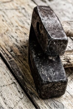 old steam hammer metallic dark stained vintage on wooden backgroundの写真素材