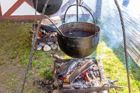 garter kitchen bowler wrought iron lunch in nature. Big pot on the coalsの写真素材