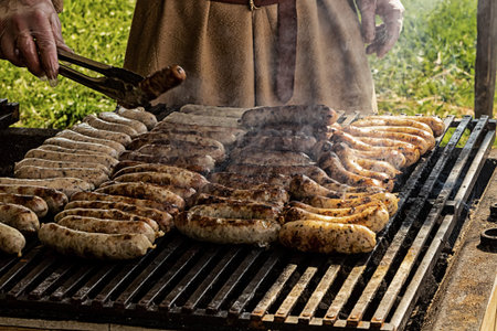 grilled delicious sausages pork beef a lot of sausages on the grill street snack
