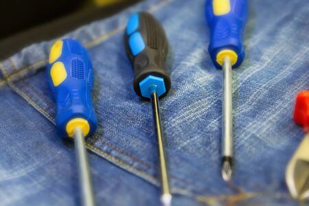 Set of hand tools for repair of three screwdrivers close-up on a blue backgroundの写真素材