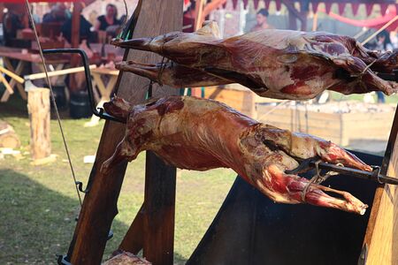 whole ram on a spit cooked on charcoal baked picnic with a delicious crustの写真素材