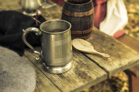 Beer mug tin ceramic traditional dishes pub. Middle ages close-up on the tableの写真素材